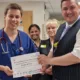 North West Anglia NHS Foundation Trust Chief Medical Officer, Dr Callum Gardner presents Dr Dylan Whitaker (left) with his Outstanding Individual of the Month certificate.