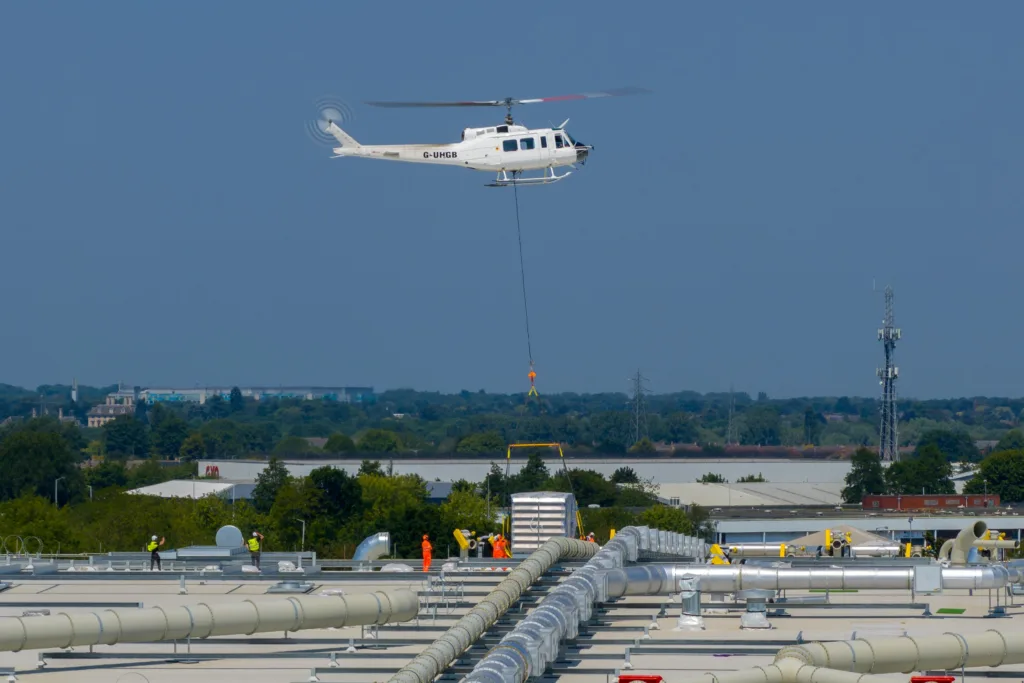 A 625,000ft sq ft factory complex under construction in Peterborough is using a Bell 205A-1 Helicopter (Helilift Services) to move construction materials to the roof of the massive factory.,Delta Park, Peterborough
Saturday 10 June 2023. 
Picture by Terry Harris.