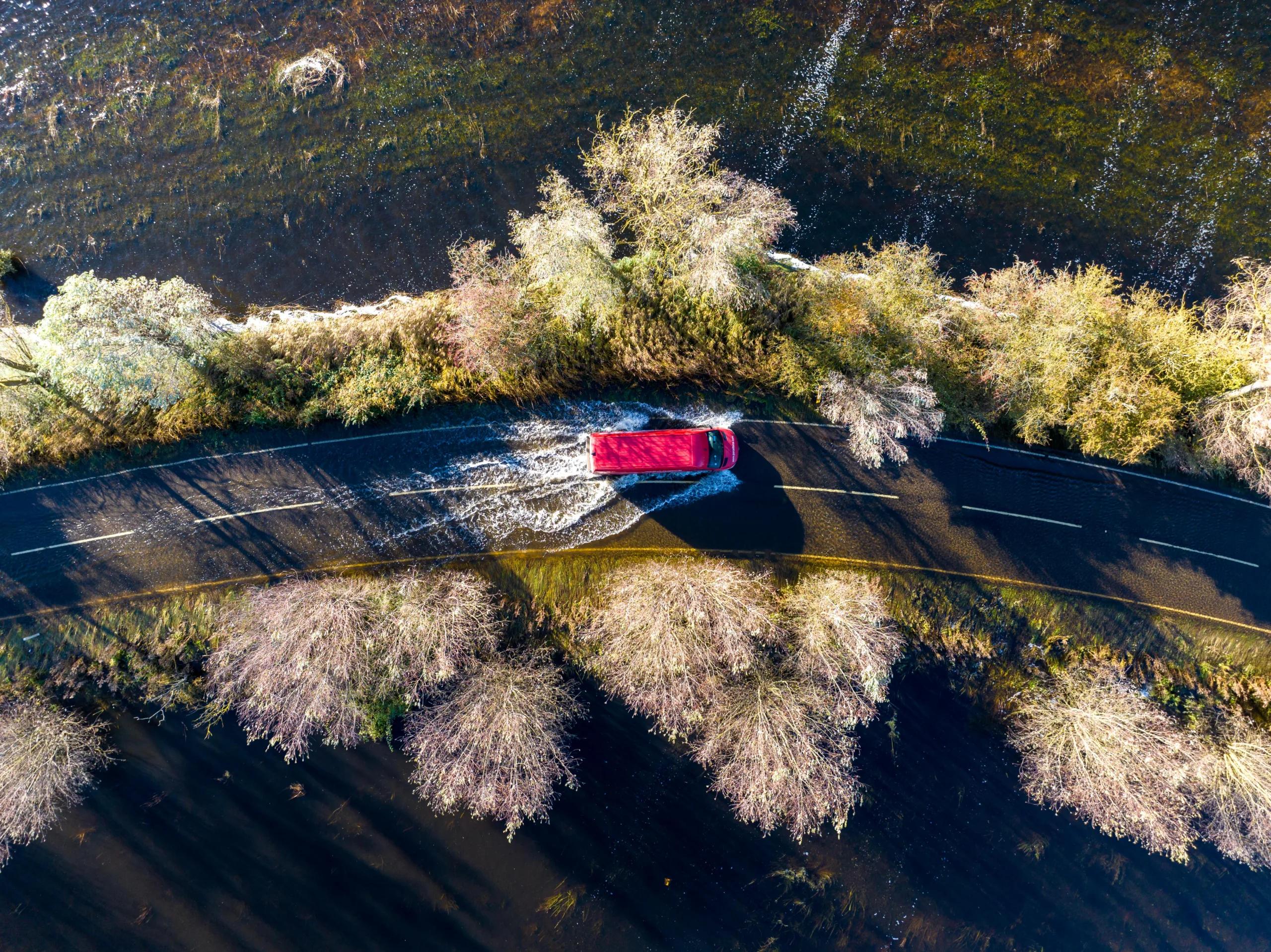 A1101 at Welney where many have chosen to find alternative routes today as water levels rise and most motorists have avoided, including those who attempted to cross but changed their mind. Bigger vehicles are still going through. PHOTO: Terry Harris for CambsNews