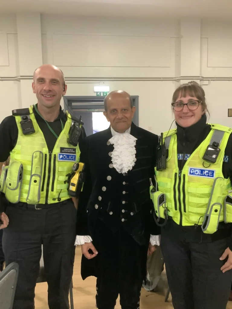 High Sheriff of Cambridgeshire, Dr Bharatkumar Khetani, cut the birthday cake as Walsoken Village Hall Community Coffee Morning celebrated its 2nd anniversary. Local police dropped in for a cuppa and cake. PHOTO: Wisbech Tweet 
