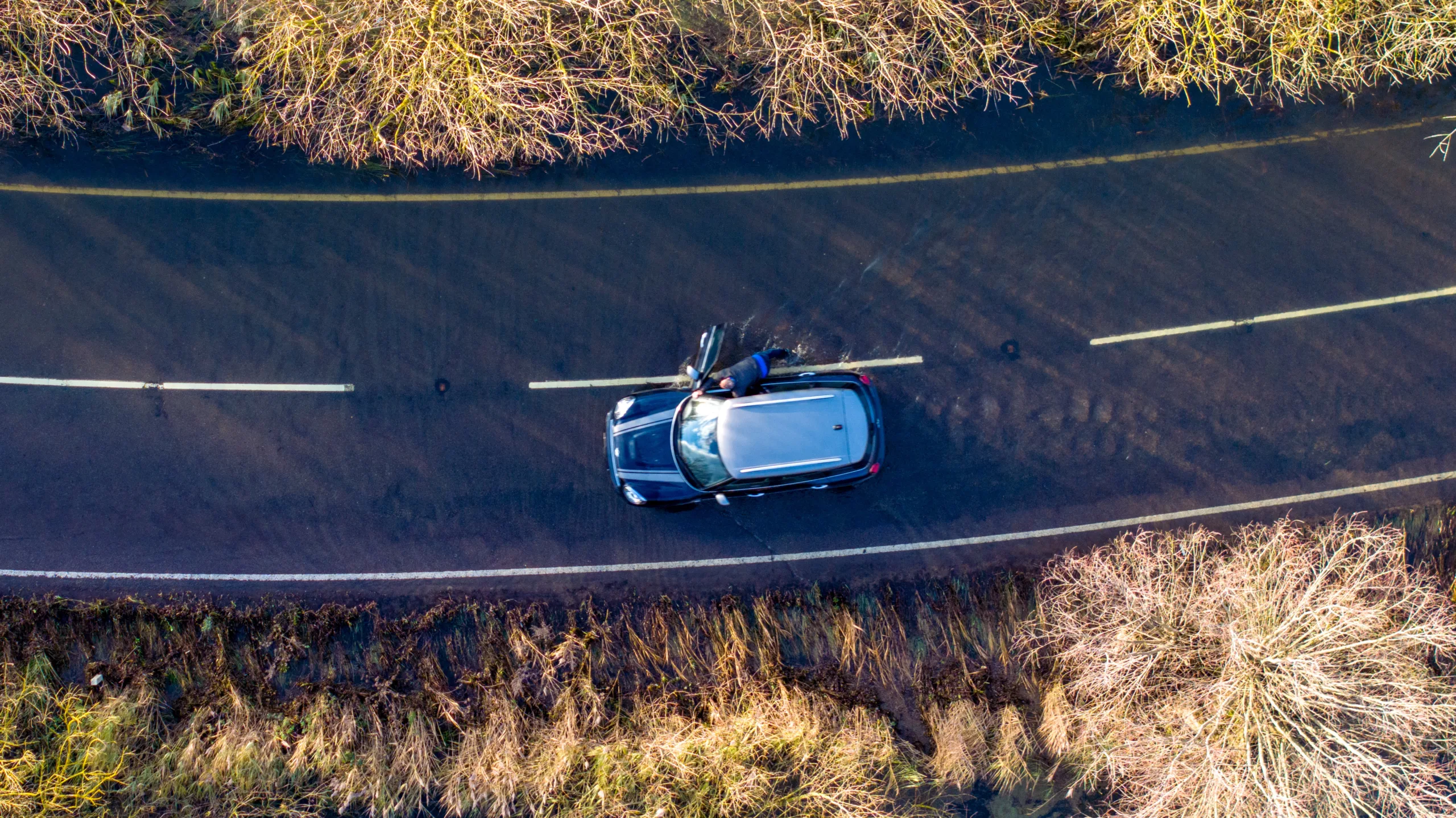 Driver pushing his car on the flooded A1101 in Welney in this morning (Mon). PHOTO: Bav Media