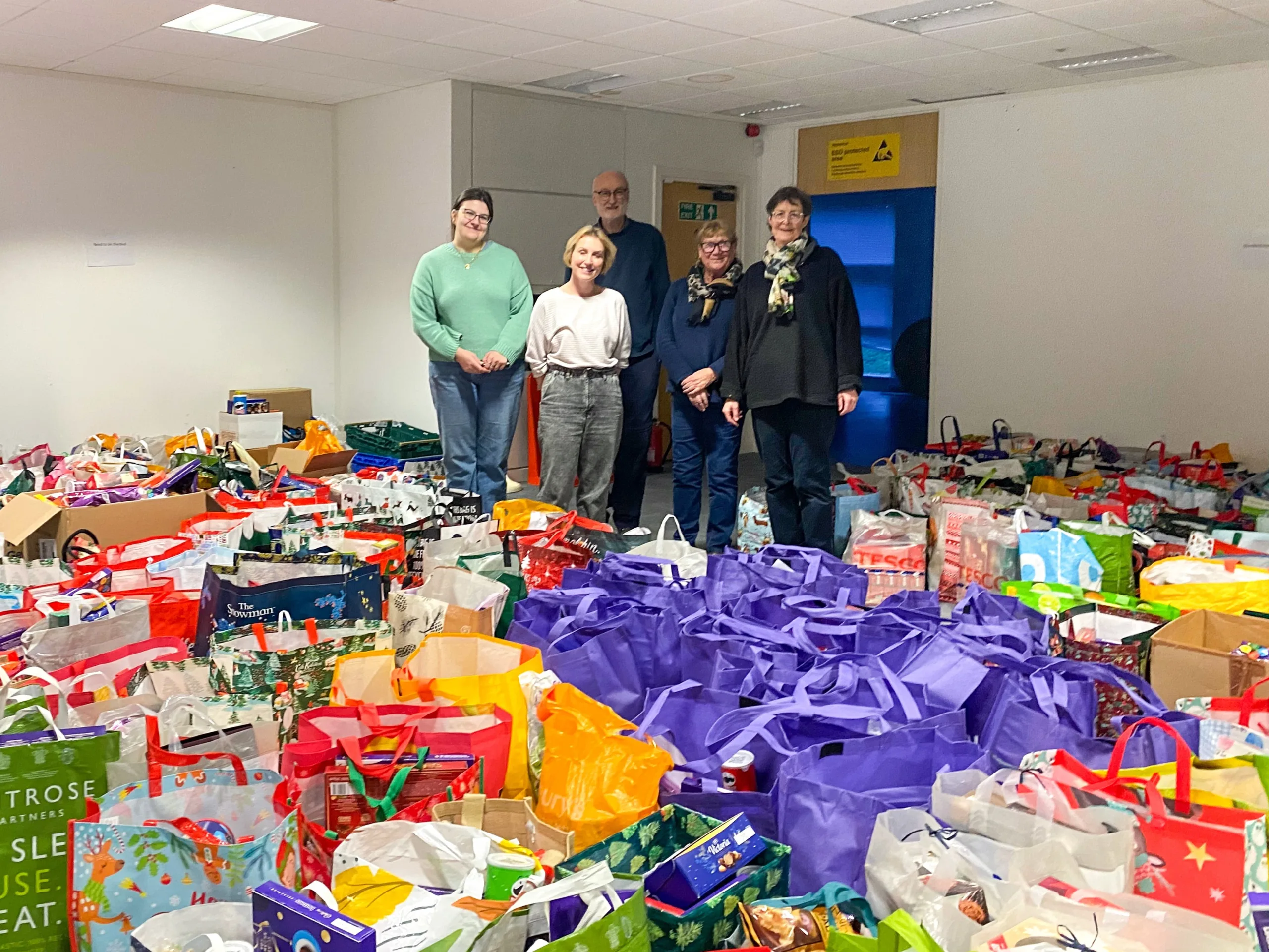 Local organiser, Kate McIntosh (L) and foodbank volunteers with donated hampers