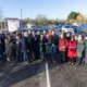 Ribbon-cutting celebration time: Getting ready to officially open Manea Station car park is Dr Nik Johnson, Mayor of Cambridgeshire & Peterborough (centre), with local MP Steve Barclay; Cllr Chris Seaton, Fenland District Council’s Cabinet member for transport and Chairman of the Hereward Community Rail Partnership; Steve Emery, former parish councillor and Hereward Community Rail Partnership board member; Cllr Ben Bonos, Chairman of Manea Parish Council; Jonathan Denby, Head of Corporate Affairs for Greater Anglia; and other partners, board members and representatives involved in bringing the project to fruition.