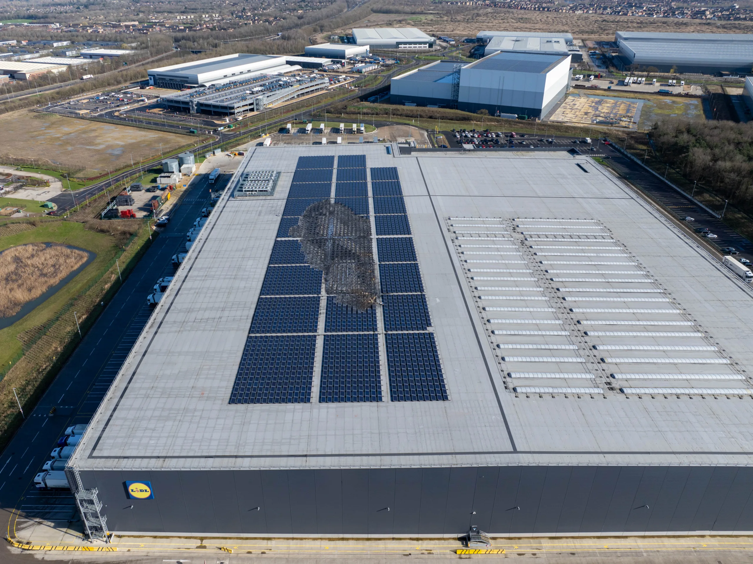 It was back to business shortly afterwards for Lidl distribution centre in Peterborough after solar panels caught fire. 11 fire engines and around 40 firefighters, as well as a water carrier and an aerial appliance, were quickly on the scene. PHOTO: Terry Harris