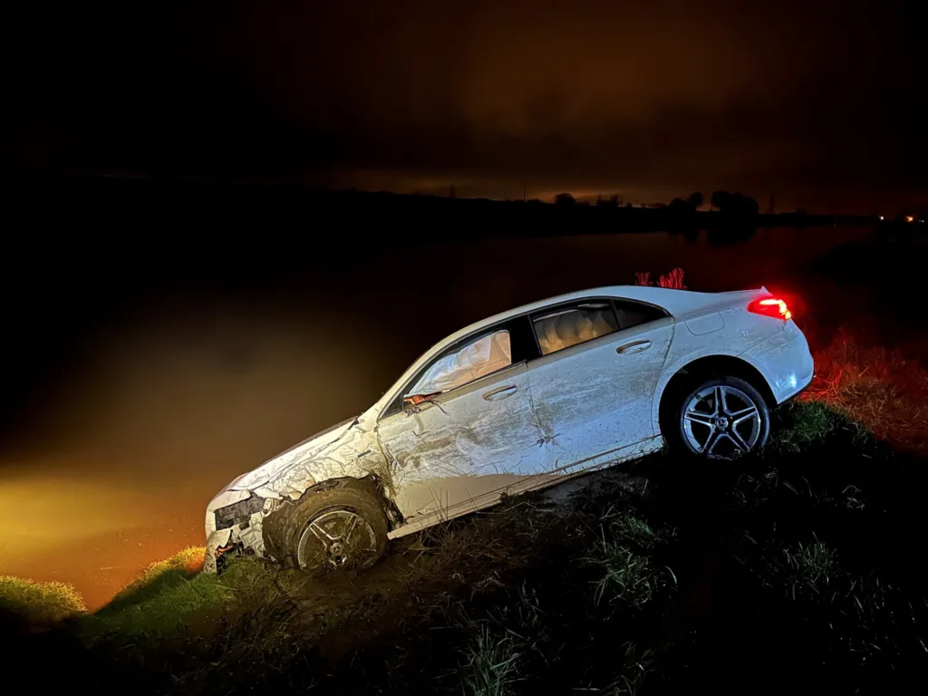 A white Mercedes had hit a stationary parked vehicle that had been party left in the carriageway with no lights on.