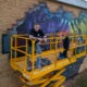 Nathan Murdoch working on a mural on the wall of the Key Theatre, Peterborough.  Embankment, Peterborough Wednesday 08 May 2024. Picture by Terry Harris.