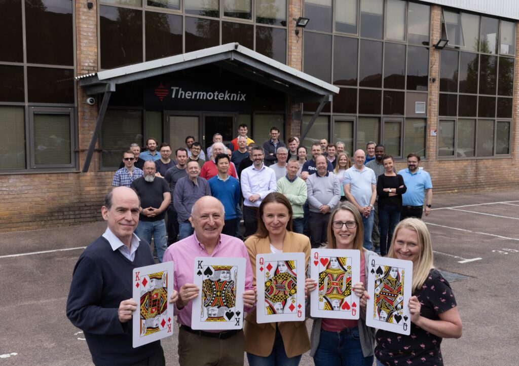 Thermoteknix celebrates a fifth Royal award. Pictured front - from left - Bruce Cairnduff (Engineering Manager), Richard Salisbury (Managing Director and Company Founder), Anna Kwiecień (Purchasing Administrator), Hollie Walsh (Sales Co-Ordinator) and Louise Barton (Office Manager) celebrating their success in securing another Royal award with Thermoteknix staff outside their headquarters in Cambridge, United Kingdom.