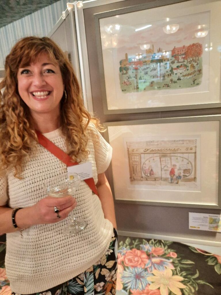 Illustrator Roxana de Rond with two of her drawings of Cambridge 