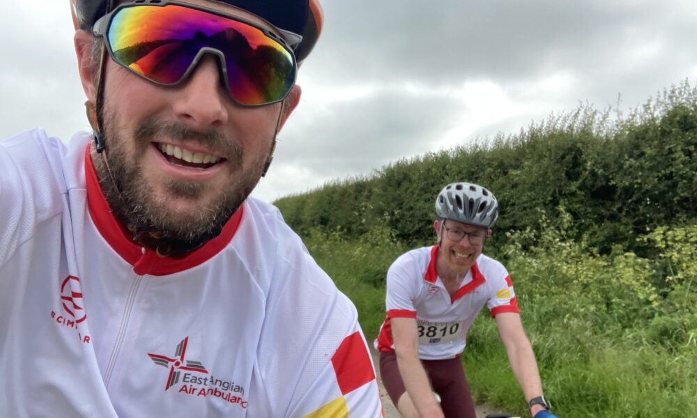 Keiran Williams (L) and Adam Clarke (R) at the Norwich 100 riding in East Anglian Air Ambulance kit