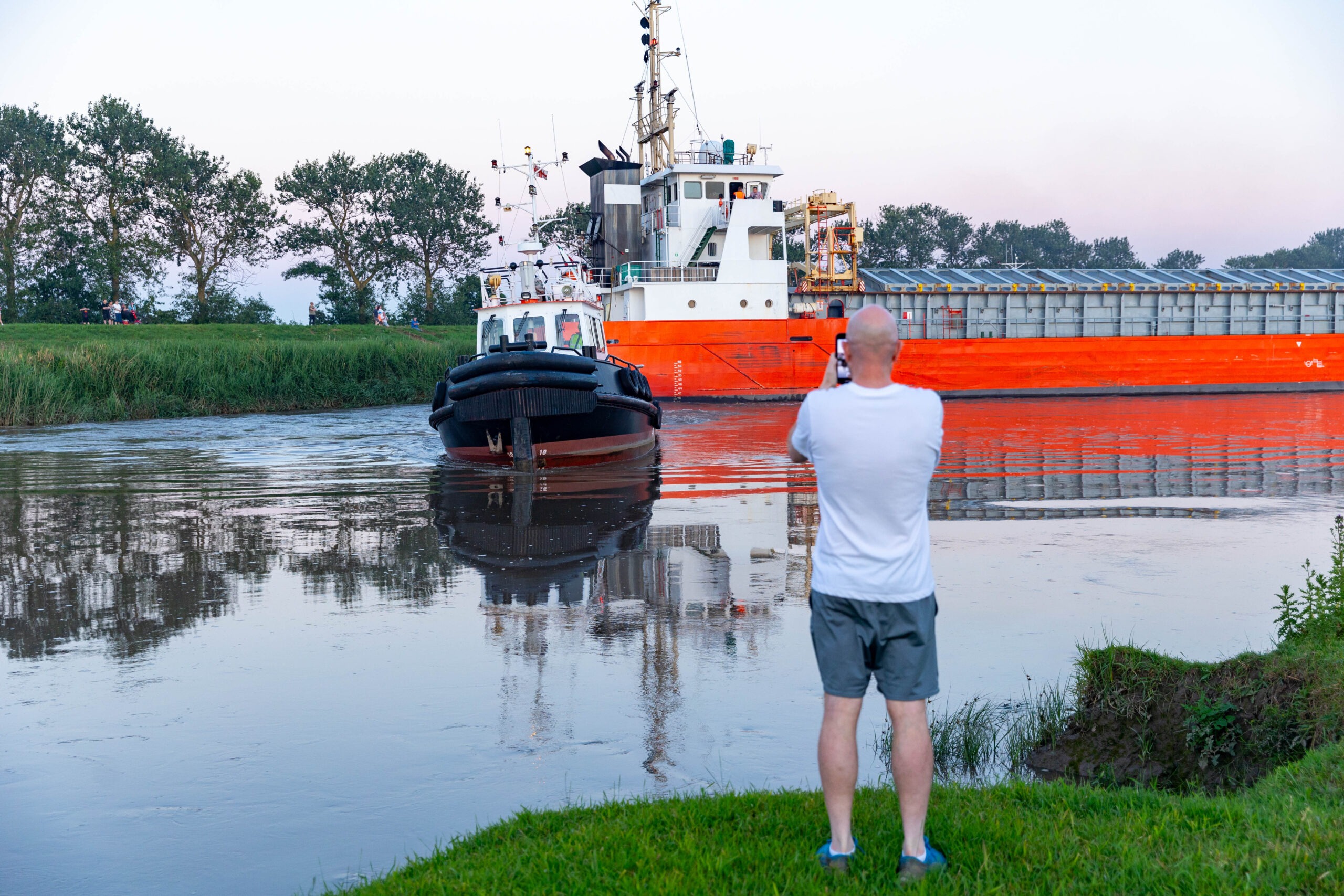 Spectators gathered by the River Nene in Wisbech as the Baltic Arrow, with its cargo of timber from Latvia, was finally freed and pulled into port. PHOTO: Terry Harris